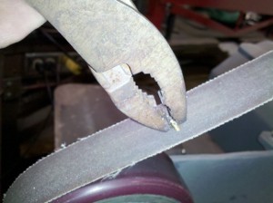 Sanding the end of the piece of brazing rod