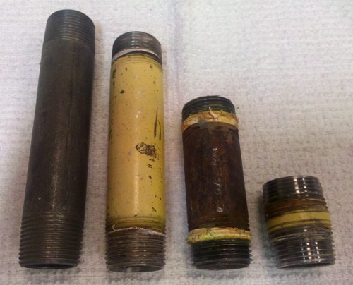Various sizes of black pipe nipples