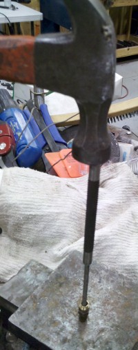 Hammering and expanding the brass plug
